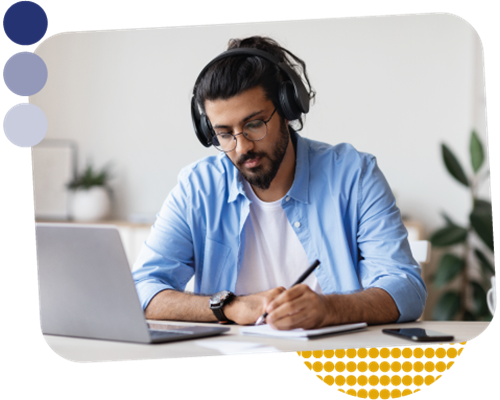 Person doing some digital learning on a laptop computer and writing in a notepad